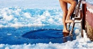 A short, sharp, cold-water swim may beat painkillers Man is going to swim in the ice hole at sunny day
