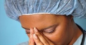 Easing workplace stress demands teamwork Crying nurse with her hands on her face