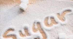 The Sugar Wars: Have the ill effects of sugar been overstated? Inscription sugar made into pile of white granulated sugar